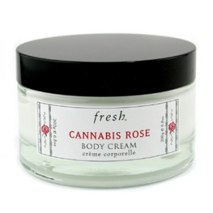 fashion shot of fresh cannabis rose body cream in a jar