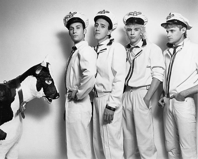 Lory Kohn's band The Milkmen, Steven Solomon, Tim Pantea, and Rick Wilson, pose with Bessie the Cow